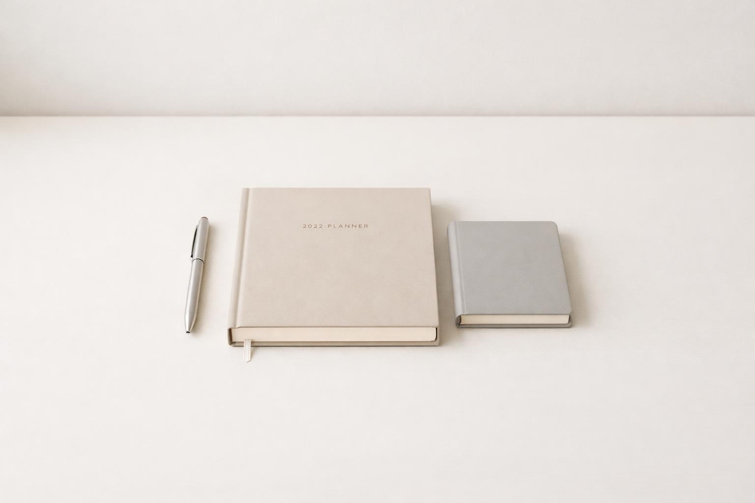 Calm desk setup with planner, pen, and notebook for intentional planning