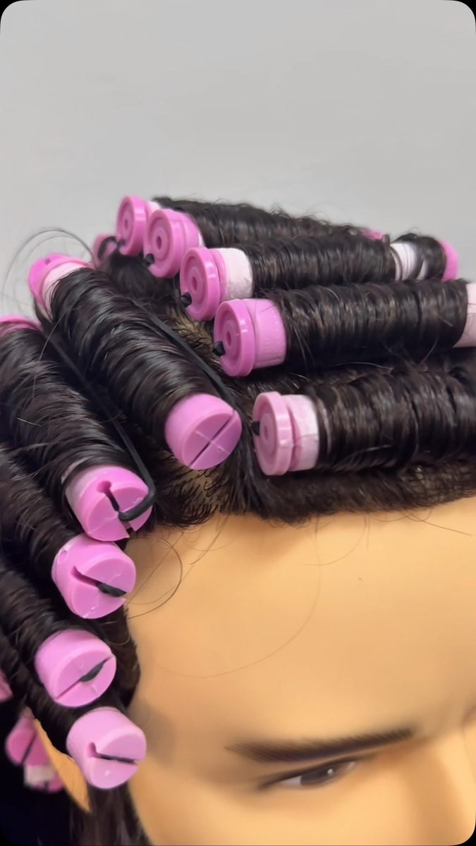 Pink perm rods along the hairline