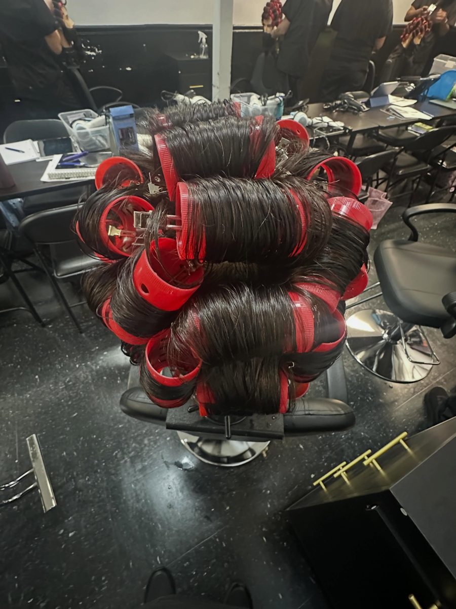 Long dark hair set in red velcro rollers