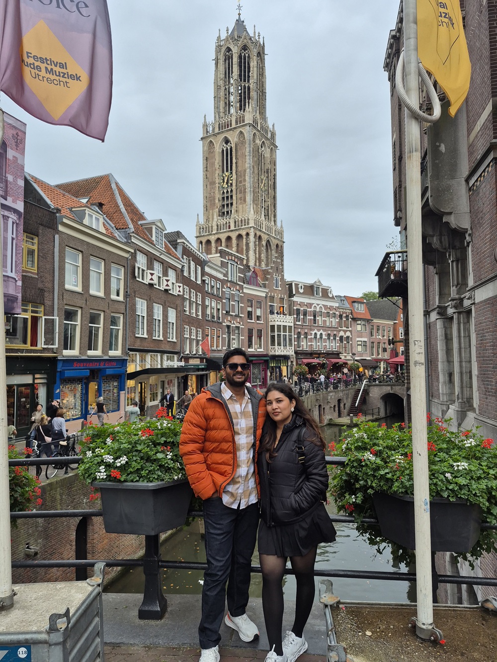 Family beside a Utrecht canal with the Dom Tower in the background