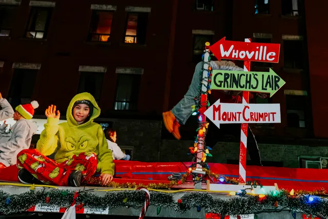 A Grinch float with signposts reading Whoville, Grinch's Lair and Mount Crumpit.