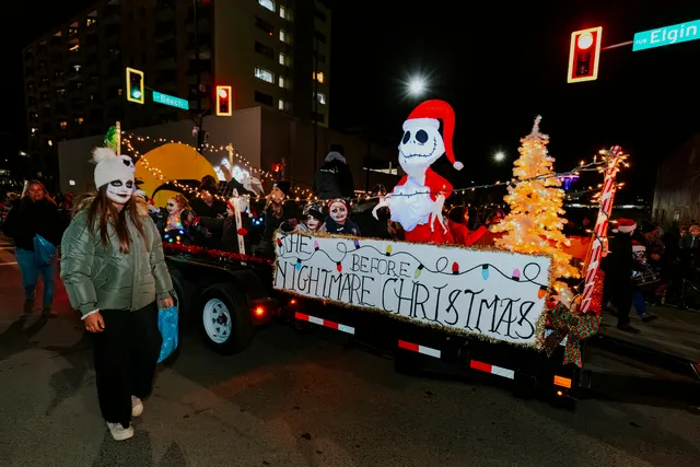 A Nightmare Before Christmas float carries a lit Jack Skellington figure and a Christmas tree.