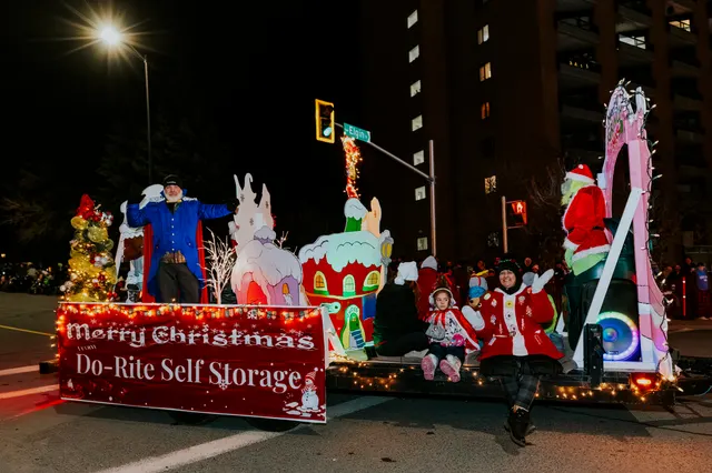 A whimsical Christmas float reads Merry Christmas from Do-Rite Self Storage, with riders waving.