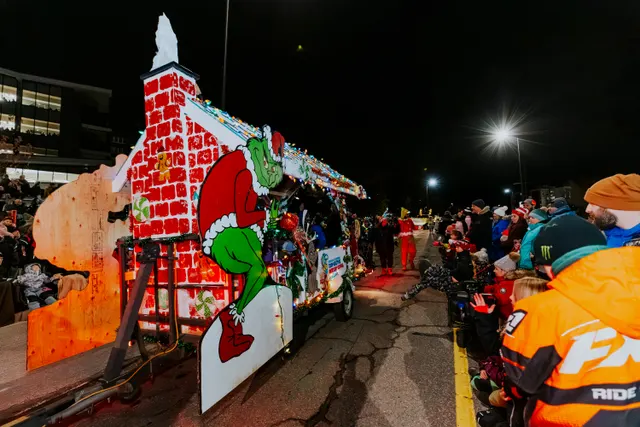 A float built as a brick chimney with the Grinch climbing out of it.