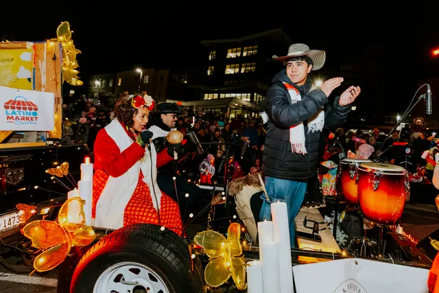 Performers sing and play conga drums on a Latino Market float in the parade.