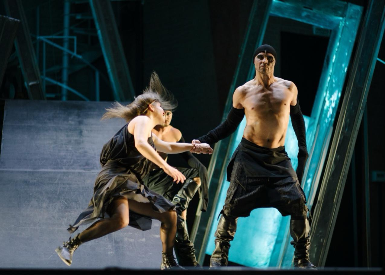 Man and woman in a futuristic performance symbolizing the impact of AI on intimacy and human relationships