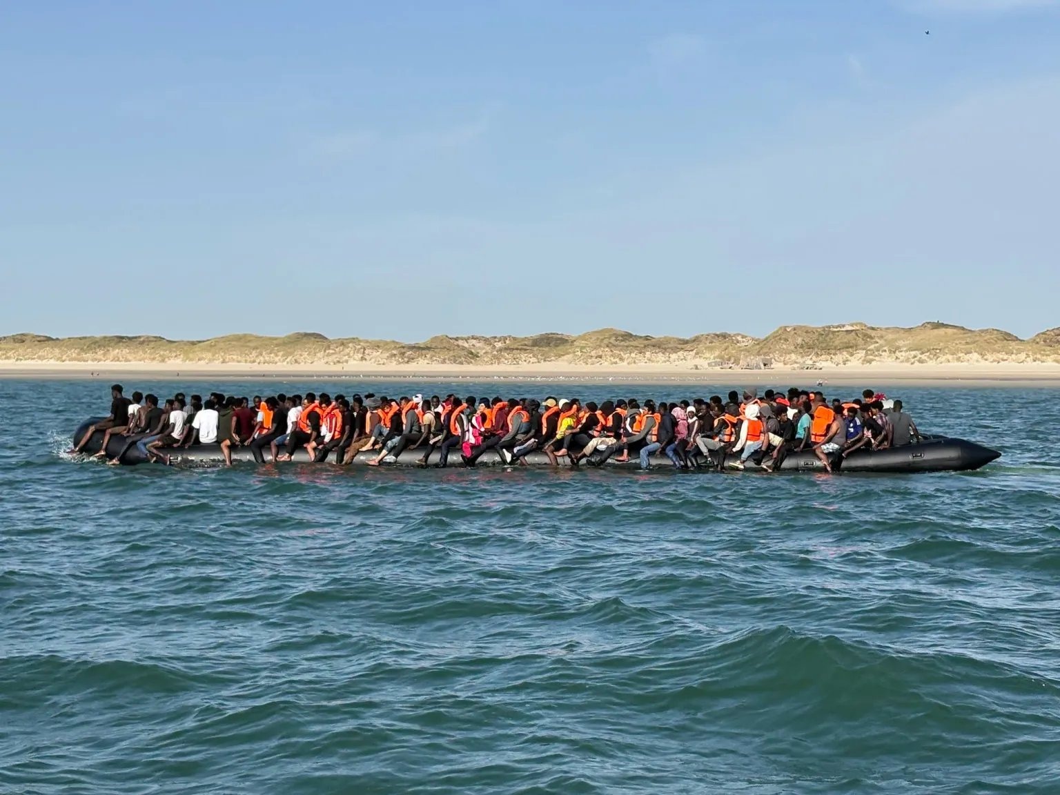 A record 230 migrants packed a single large dinghy to reach Dover, as Friday's crossings pushed the two-day running total past 615 despite heavy thunderstorms and strengthening winds.