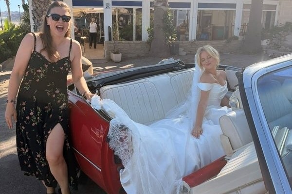 A vintage red Cadillac convertible, the car in which Emily Atack arrived at her Mojácar ceremony — her gown designed by Avenue by Josephine Scott.