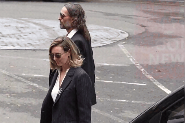 Russell Brand smiles in the dock as his wife gives evidence at Southwark Crown Court, having shown little emotion throughout the trial until that point.