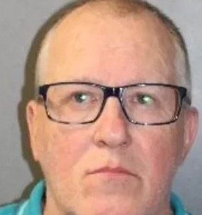 Mark Neville, 65, wearing a teal polo shirt, in a Metropolitan Police custody photograph taken after his arrest on 26 September 2025, two days after the Dingley Road attack.