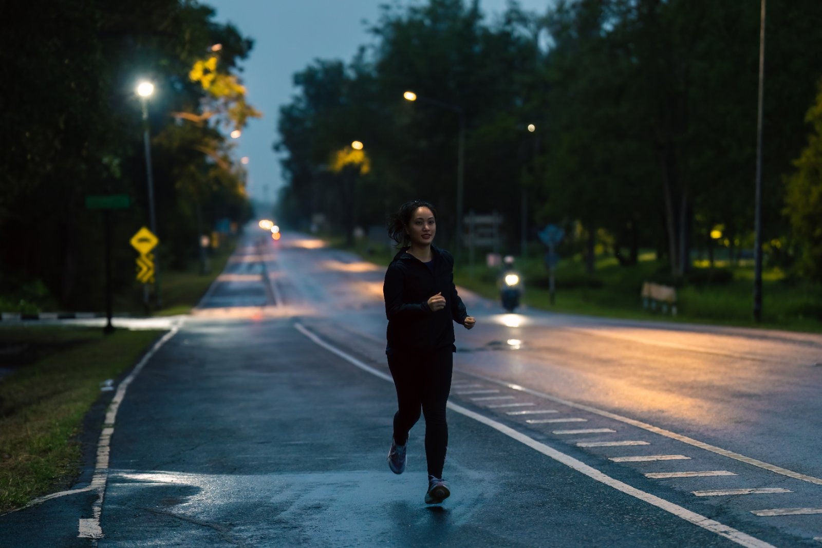 A woman running alone at night. Sport England research finds 52 per cent of women now fear being followed when exercising outdoors after dark — more than three times the rate at which men abandon outdoor exercise once…