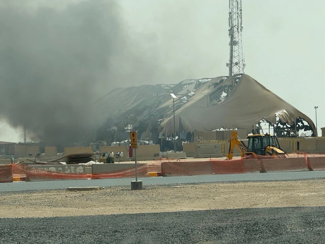Collapsed and burning structures at a US military base, black smoke rising overhead, as more than 125,000 people have been driven from their homes by Yemen's latest fighting.