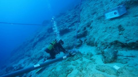 A diver examines the wreck site off Kekova Island, Antalya — the Early Bronze Age trade ship, roughly 10 metres long, sank in just 30 metres of water.