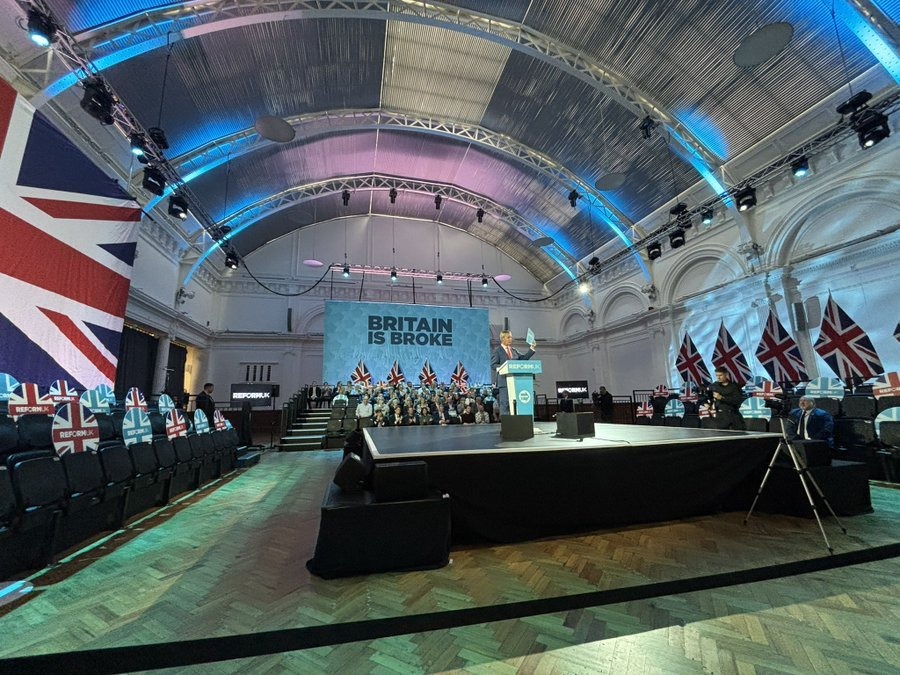 Nigel Farage at a half-empty Reform UK event, as the latest Ipsos poll puts his party 12 points behind Labour and four points behind the Tories.