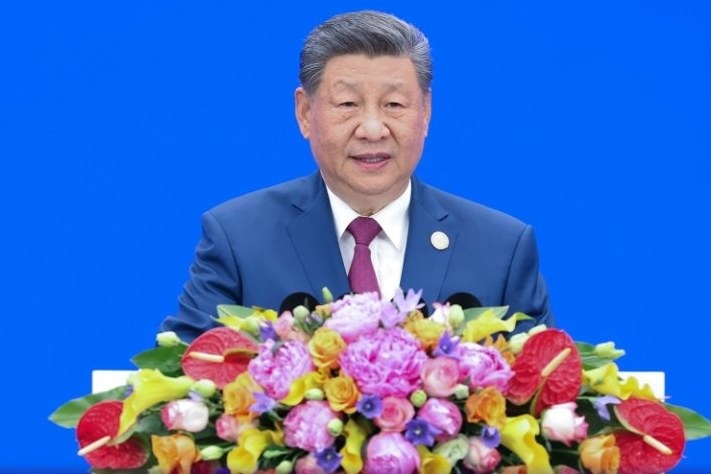 Xi Jinping at a conference promoting global AI collaboration. The Chinese president is due in Washington within days for talks with President Trump as revelations emerge that an AI "hallucination" about a Chinese ship's…