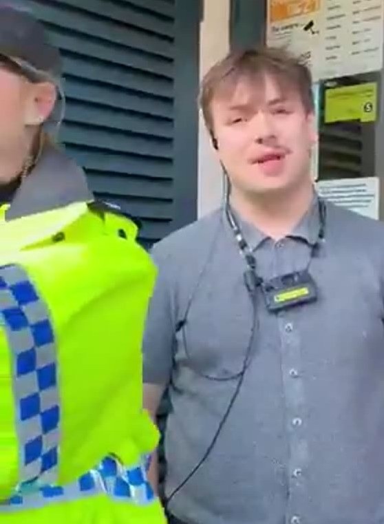 The manager, standing at the pub doorway beside a high-visibility police officer, tells those at the entrance that the restriction covers anything that "could be political.