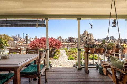 The rooftop terrace and meadow garden of the West Village penthouse, where builders had to blow soil up through a tube to create the prairie-style garden against a Manhattan skyline backdrop.