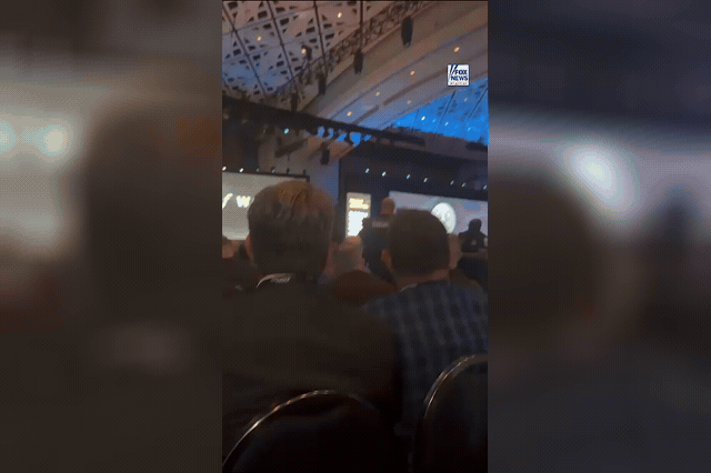 Officers carry out a protester at the US Army's annual conference in Washington DC, where demonstrators also waved 'No war on Iran' signs and accused Pete Hegseth of 'killing children in Gaza.'
