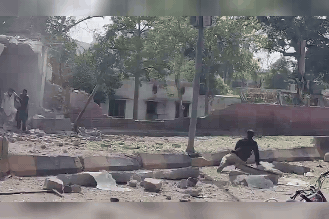The blast-damaged perimeter of a police compound in Kohat, Khyber Pakhtunkhwa, where armed gunmen simultaneously attempted to storm the facility after the explosion, exchanging fire with security forces for hours.