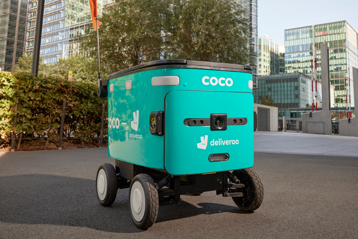 A Coco Robotics autonomous delivery robot navigates a pavement, as Deliveroo launches the service in Canary Wharf with Milton Keynes, Leeds, Stockton-on-Tees and Nottingham set to follow.