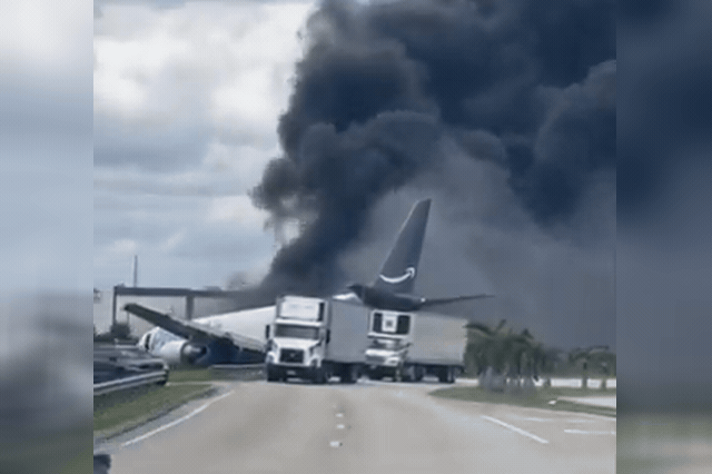 Black smoke rising near Miami airport from the Amazon Boeing 767 cargo jet that overran the runway and struck a van carrying aircraft-cleaning workers, killing all five occupants.