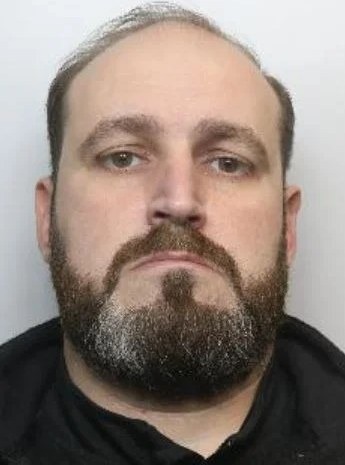 Robert Veza, who was in his probation period at the time of his offending, in a South Yorkshire Police custody photograph.