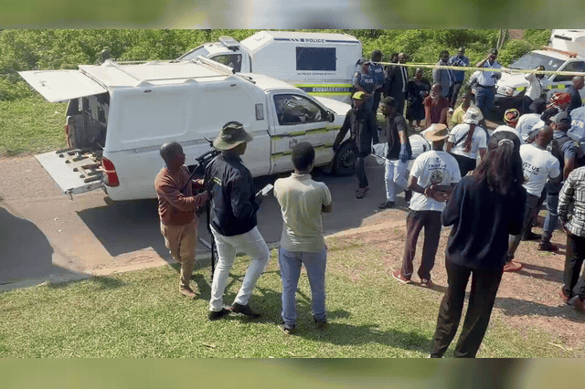 Bodies of the 11 victims are loaded into South African Police Service forensic pathology vans after three gunmen stormed a KwaMakhutha township house party south of Durban, killing 11 — including a pregnant woman.