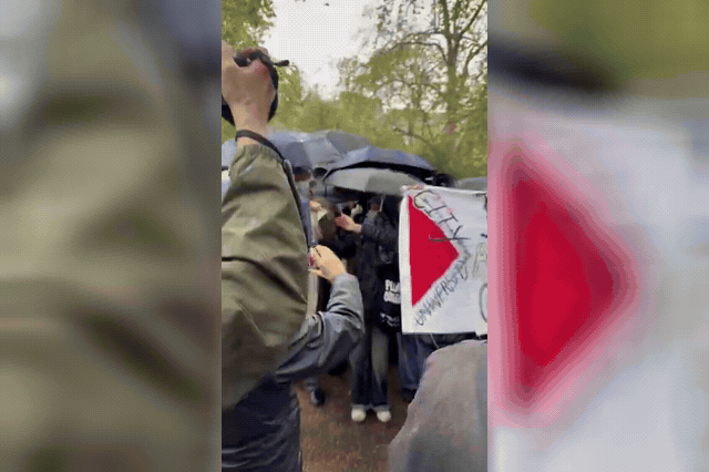 A masked protester among demonstrators at Lincoln's Inn Fields, London, as counter-protesters clashed with marchers near Russell Square on the third anniversary of the October 7 attacks.