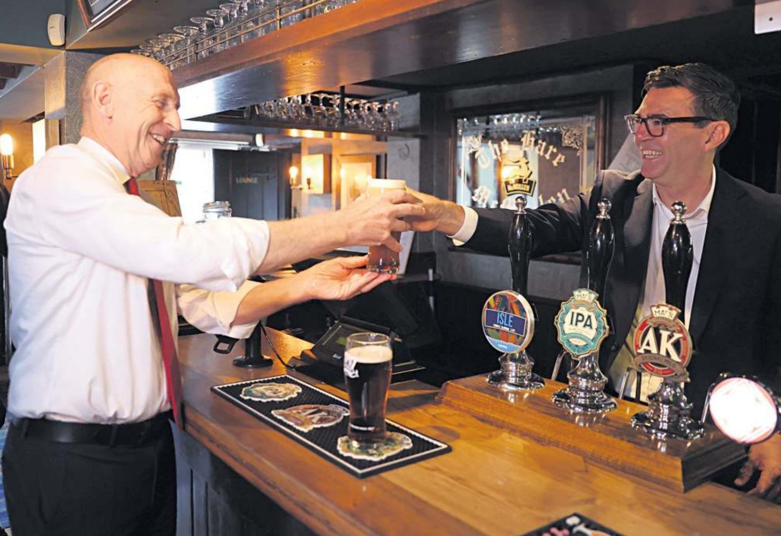 Andy Burnham, pictured with John Healey, has declined to rule out tax rises while saying Labour will honour its manifesto commitments.