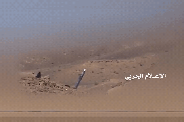 A Houthi missile on rocky desert terrain in Yemen, where an AI-assisted cell developed self-correcting ballistic missiles targeting ranges of more than 1,500 miles using Claude instead of human weapons engineers.