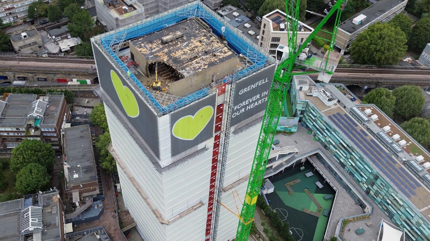 Grenfell Tower, where a 2017 fire killed 72 people after cost-cutting decisions led to combustible cladding being installed, with 54 individuals now referred to prosecutors over potential corporate manslaughter charges.