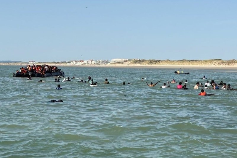 A overcrowded Channel dinghy carrying migrants, as Major General Duncan Capps warned MPs that smugglers are now packing up to 230 people onto single vessels, with a mass casualty incident "only a matter of time.