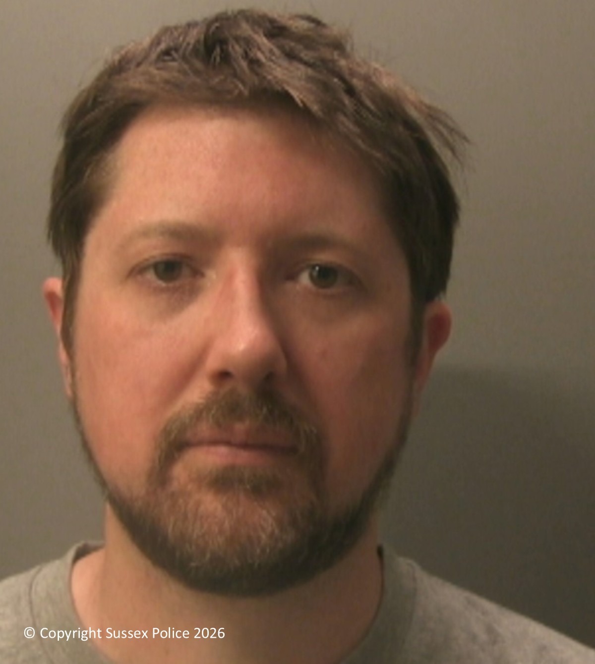 Christopher Buxey, who broke into a family home wearing a balaclava and latex gloves and was found with a rucksack containing similar items, pictured in a Sussex Police custody photograph.