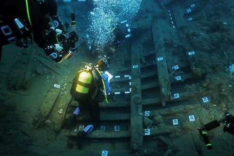 Archaeologists excavate the seabed off Kekova Island, Antalya, where three large stone anchors were found scattered across an underwater slope alongside the ancient wreck's ceramics.