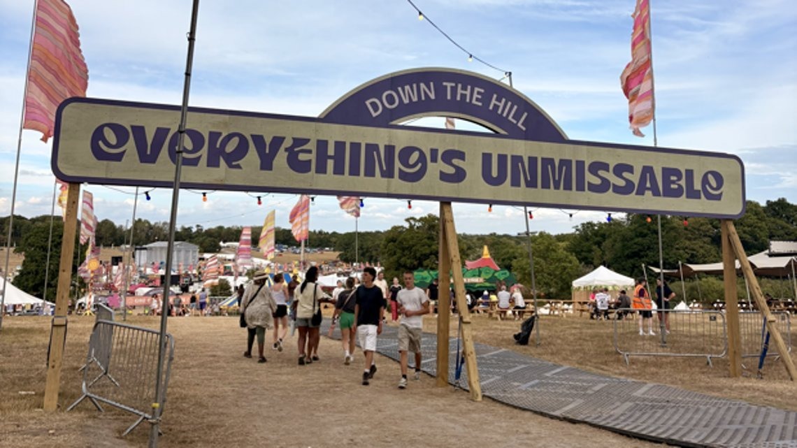 Strong winds toppled the wooden 'Everything's Unmissable' sign on the festival's opening day, Friday, prompting groups of up to 50 bystanders to help lift the timber board off those trapped beneath.