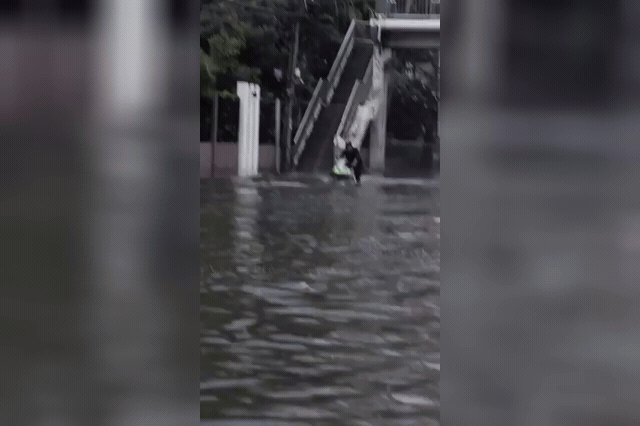 Sorn Keadsiri, 27, rides a jet ski along flood-submerged Phetchaburi Road in Bangkok, drenching motorcyclists — footage he posted on Facebook with the caption "BKK DRIFT" before deleting it by Monday morning.