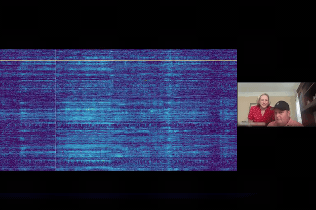 A synthetic voice speaks the words "I love you" in a 23-second Neuralink video, as a separately developed Paradromics implant also enables a woman with motor neuron disease to select words spontaneously in real time.