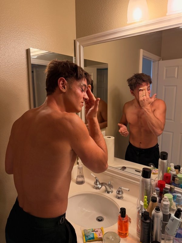 Tom Daley applying make-up during his transformation into Lady Godiva, created with the help of former RuPaul's Drag Race contestant Plastique Tiara.