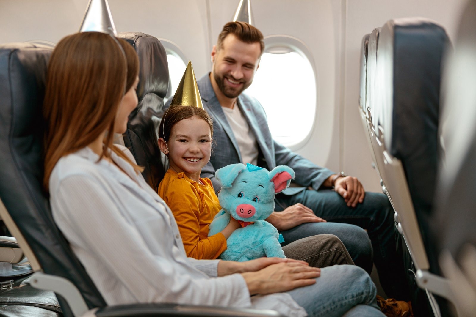 Families on a flight face extra seat-selection fees that Andy Burnham's Civil Aviation Bill would ban, along with name-correction charges on bookings.