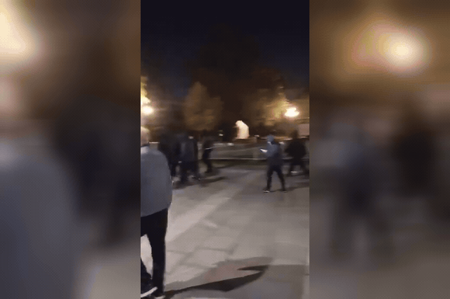 Hooded men outside the Serbian parliament building in Belgrade, as thousands of Serbian Americans are also expected to vote in today's snap election.