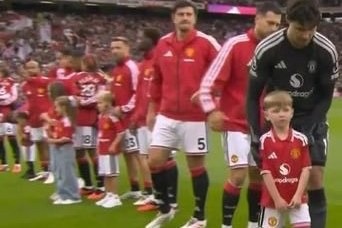 The sons of one of the fallen officers led out Manchester United as mascots, days after the King wrote to both families to express his condolences.