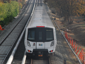 a train traveling down train tracks next to a forest