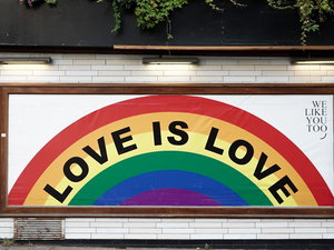 love is love wall art with brown wooden frame