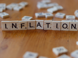 Inflation is spelled out using scrabble tiles.