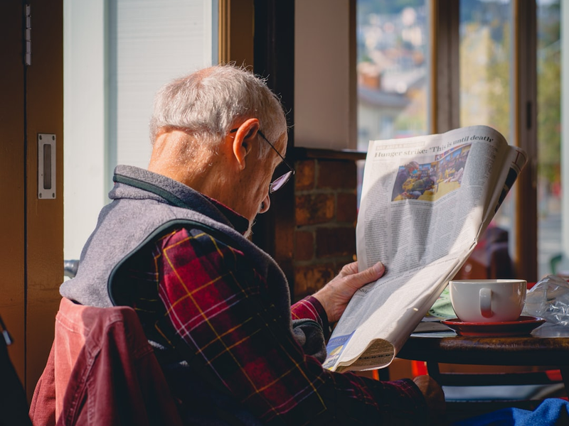 Reading a paper and drinking coffee