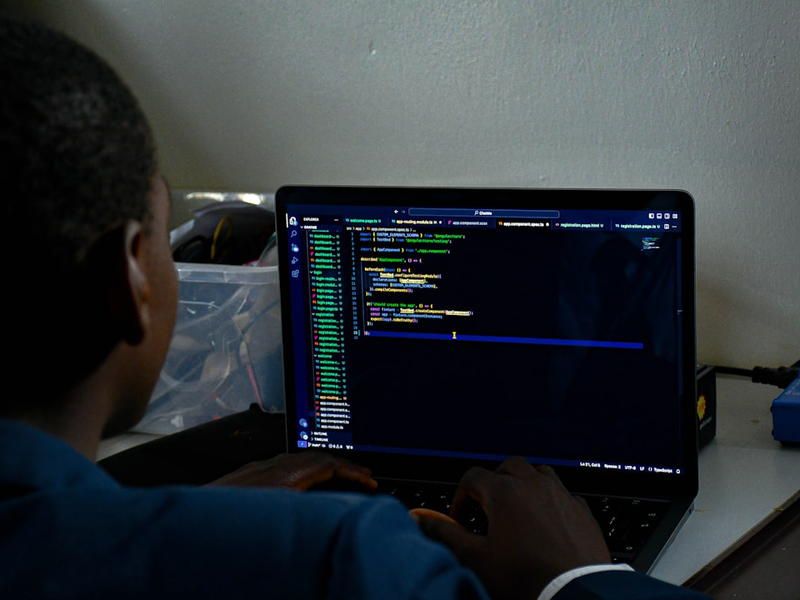 A person writing a computer code.