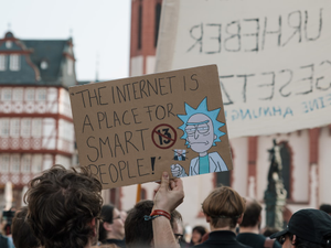 person holding brown banner