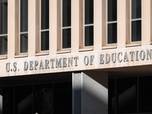 Front facade of the U.S. Department of Education building in Washington D.C., featuring large, bold letters spelling out its name.