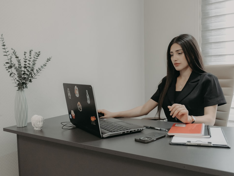 Woman working on a laptop at an office desk