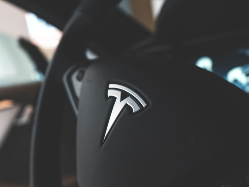 black Tesla vehicle steering wheel